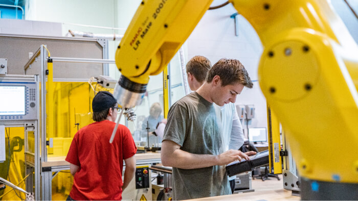 Students program robots during FANUC Training Class