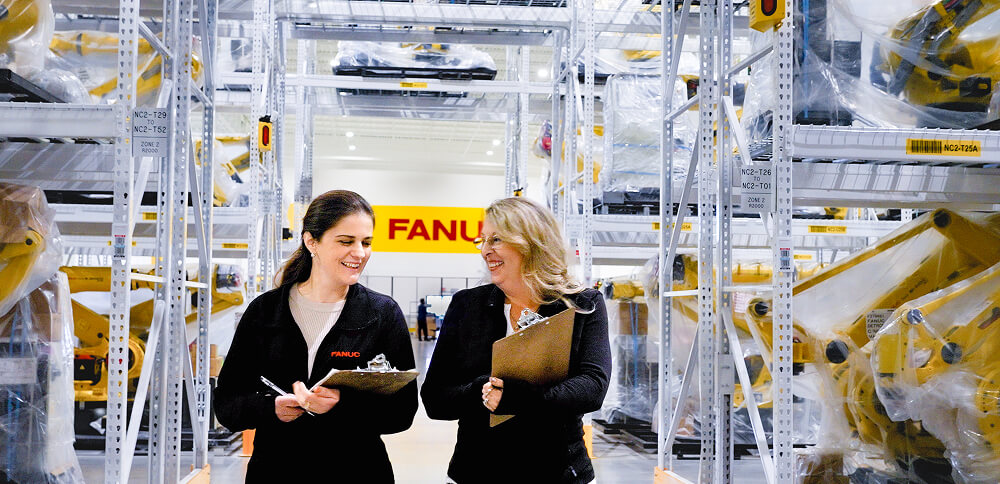 Two employees walking through factory