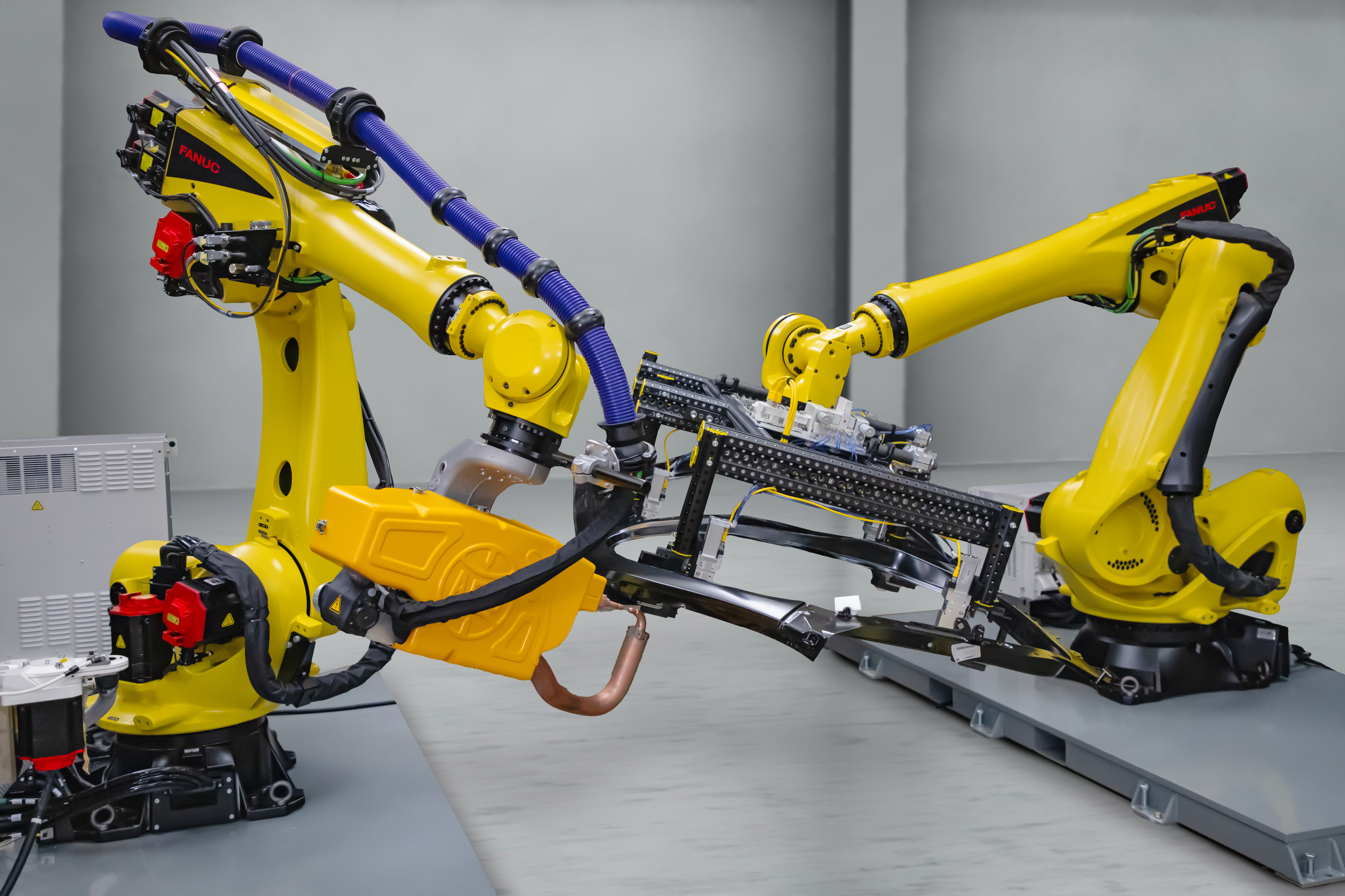 FANUC R-2000/225F-27E and R-2000/210F-31 E robots performing spot welding