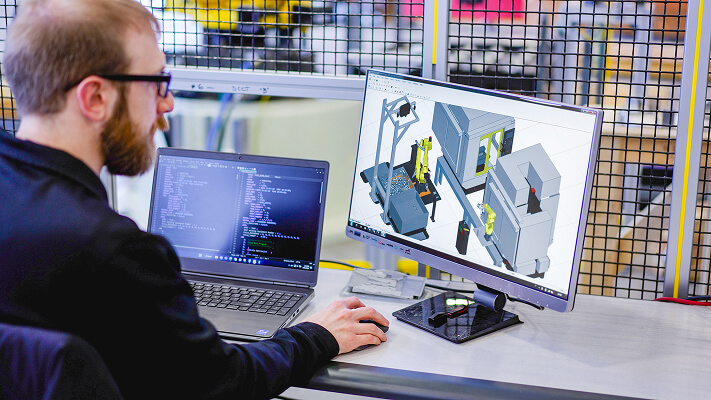 Engineer with digital twin roboguide cnc software
