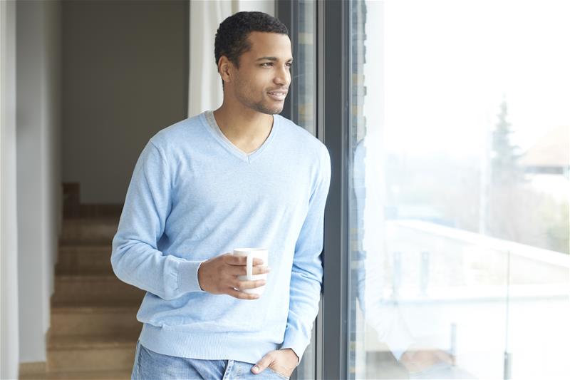 Man at window coffee stock photo