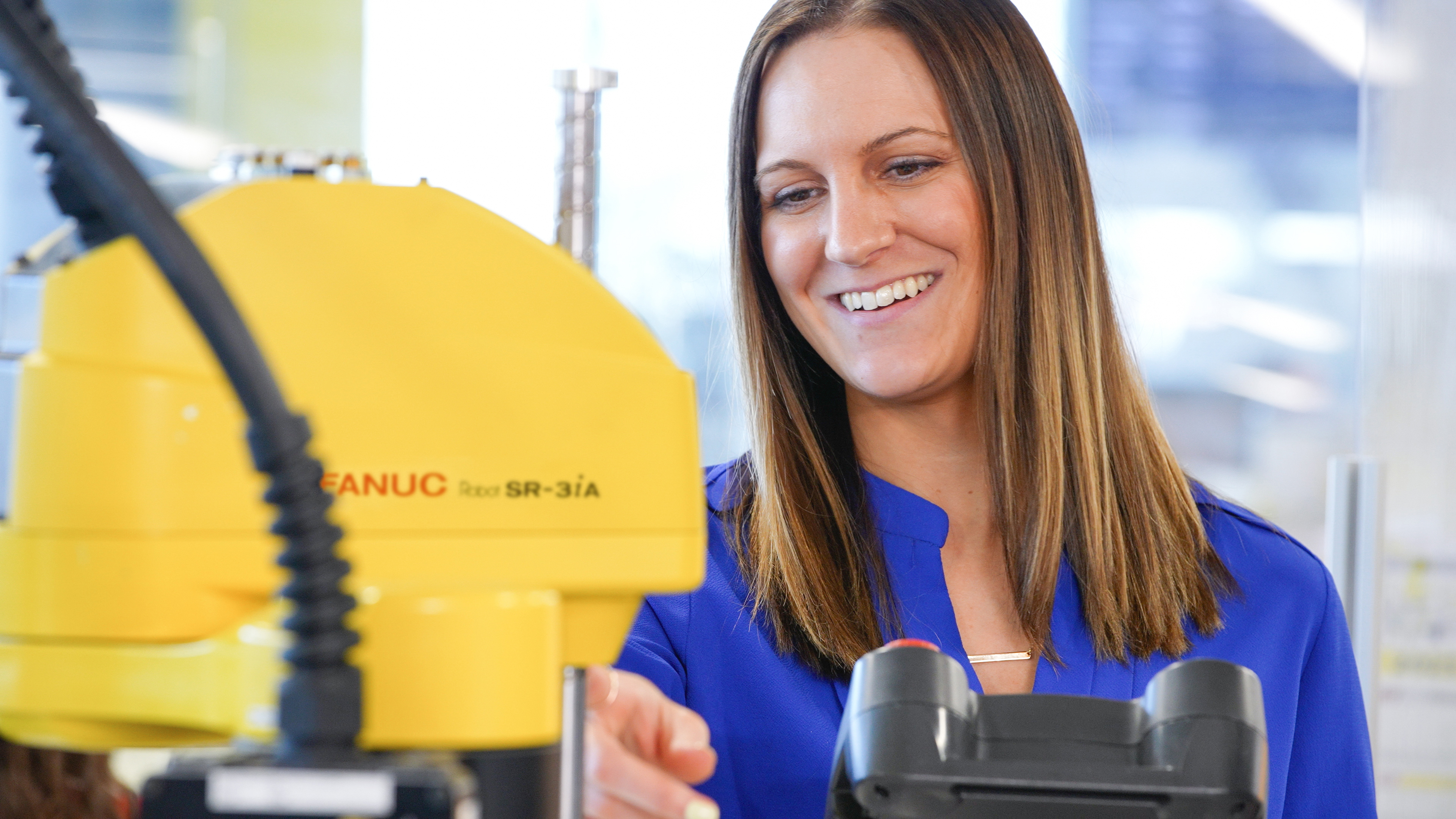 Smiling Employee with SR 3i A SCARA Robot
